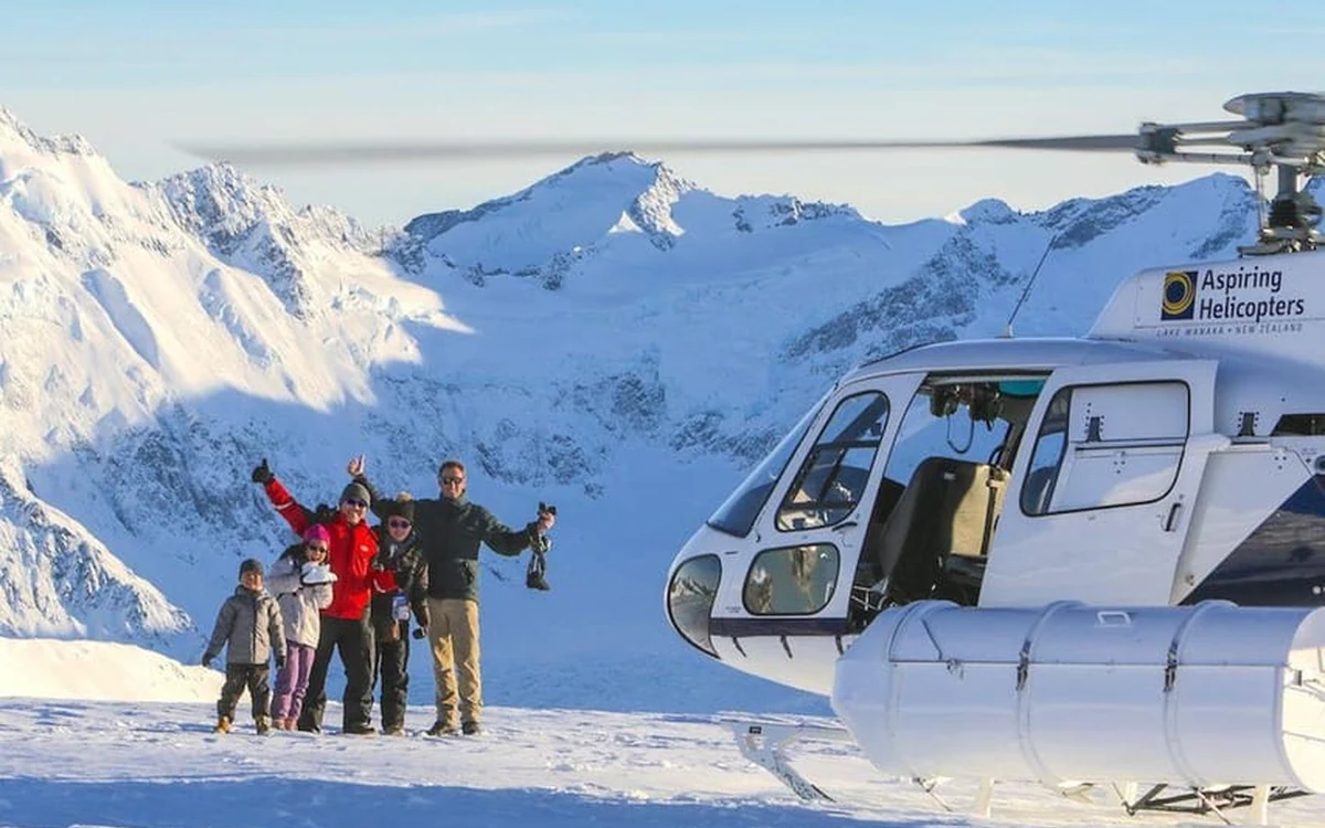 A helicopter parked on a snowfield high in the Southern Alps